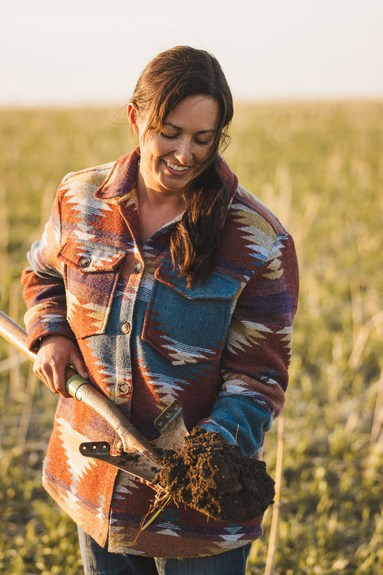 Sarah Svoboda with a shovel of soil